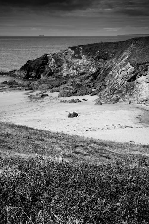 Black and White Photo of a Sandy Beach and Cliffs