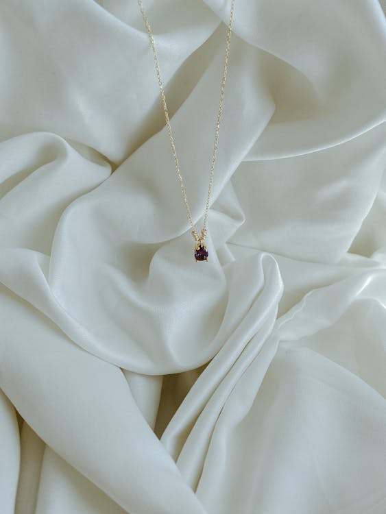 Photo of a Necklace on a White Drapery