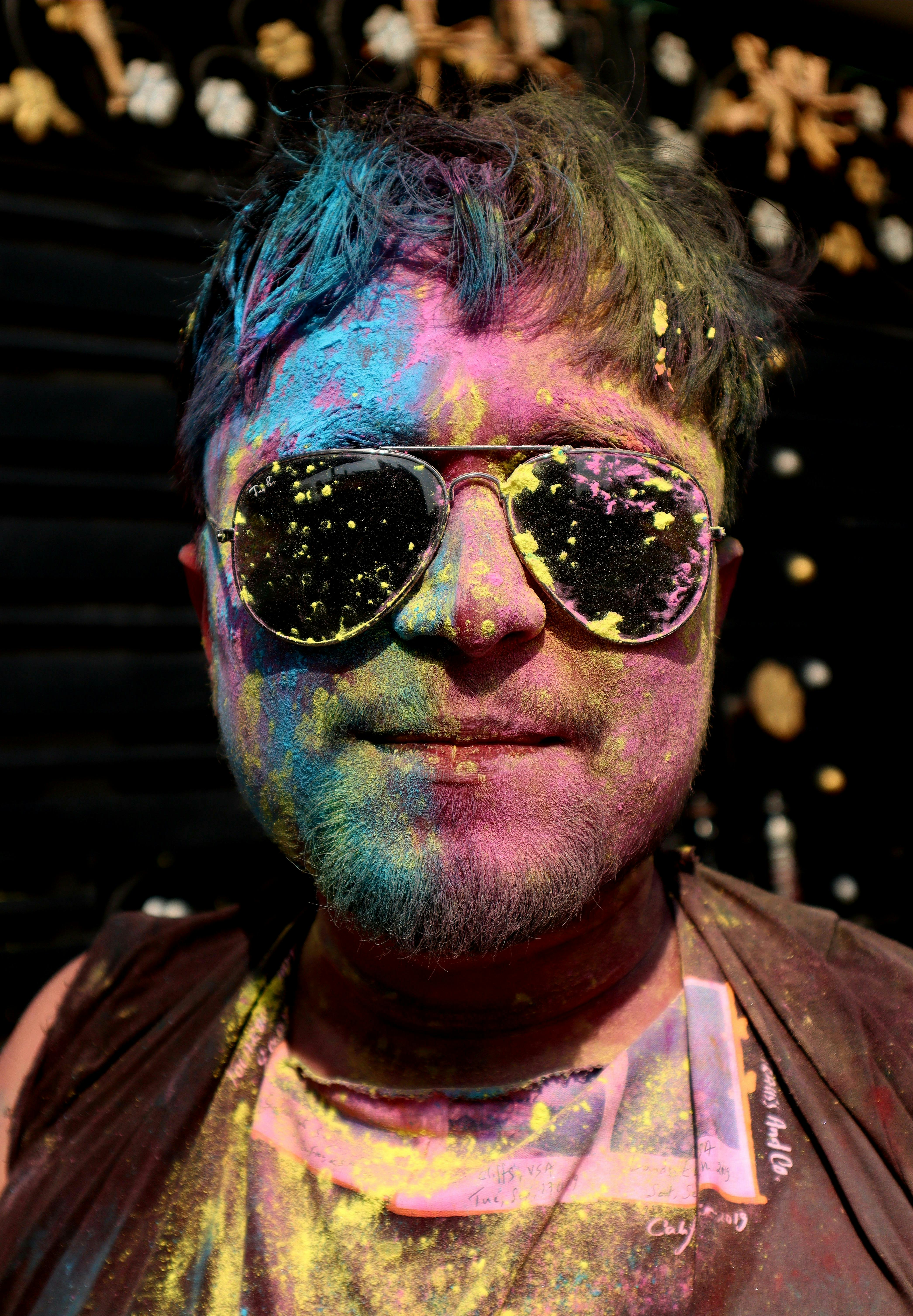 AI Generated. AI Generative. Vibrant multi color explosion holi powder boom  with handsome man portrait in sunglasses. Graphic Art 31412470 Stock Photo  at Vecteezy