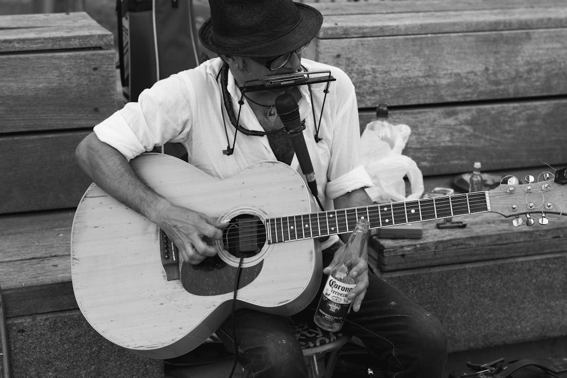 Monochrome Photo of Man Playing Guitar