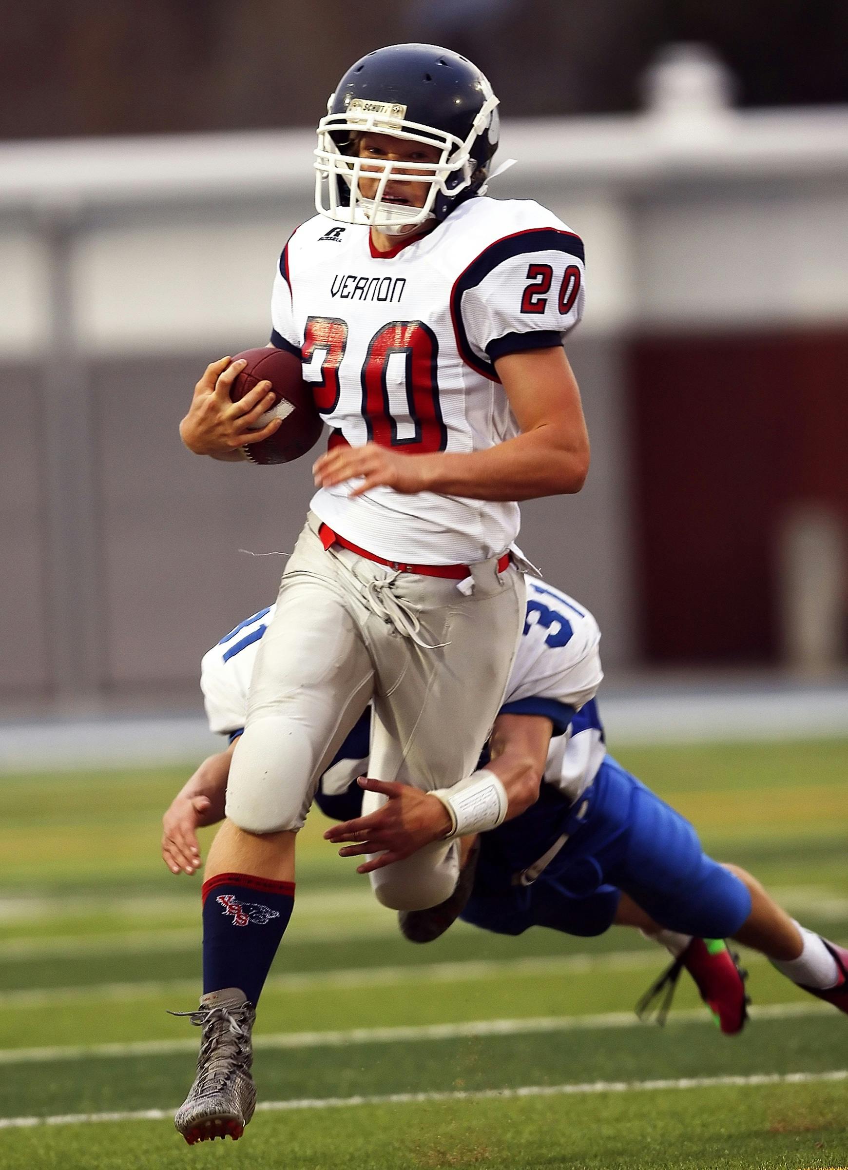 Man Dragging Down The Opponent Holding The Football Running On The