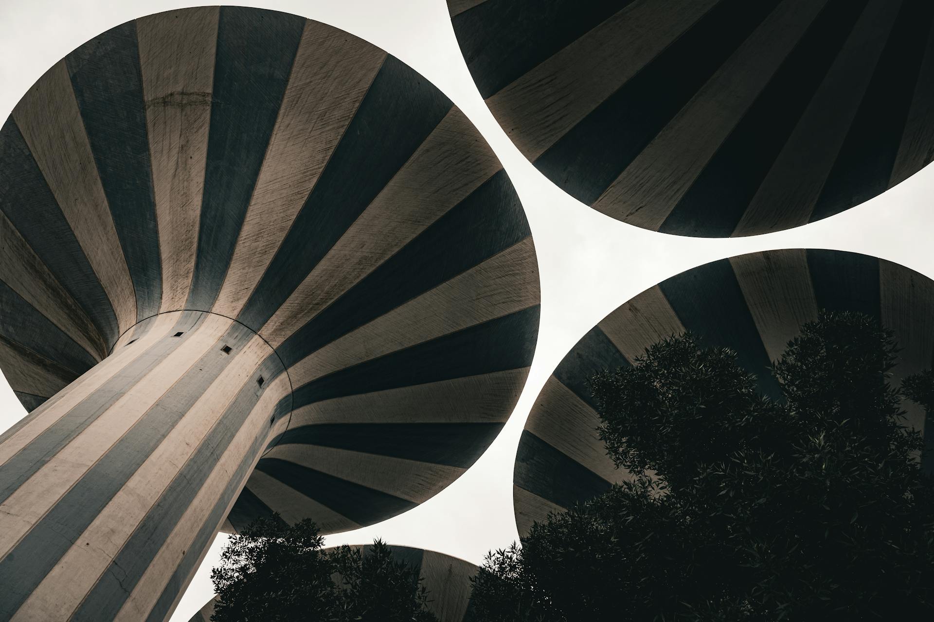 Dramatic perspective of iconic water towers in Kuwait City, emphasizing architectural design.