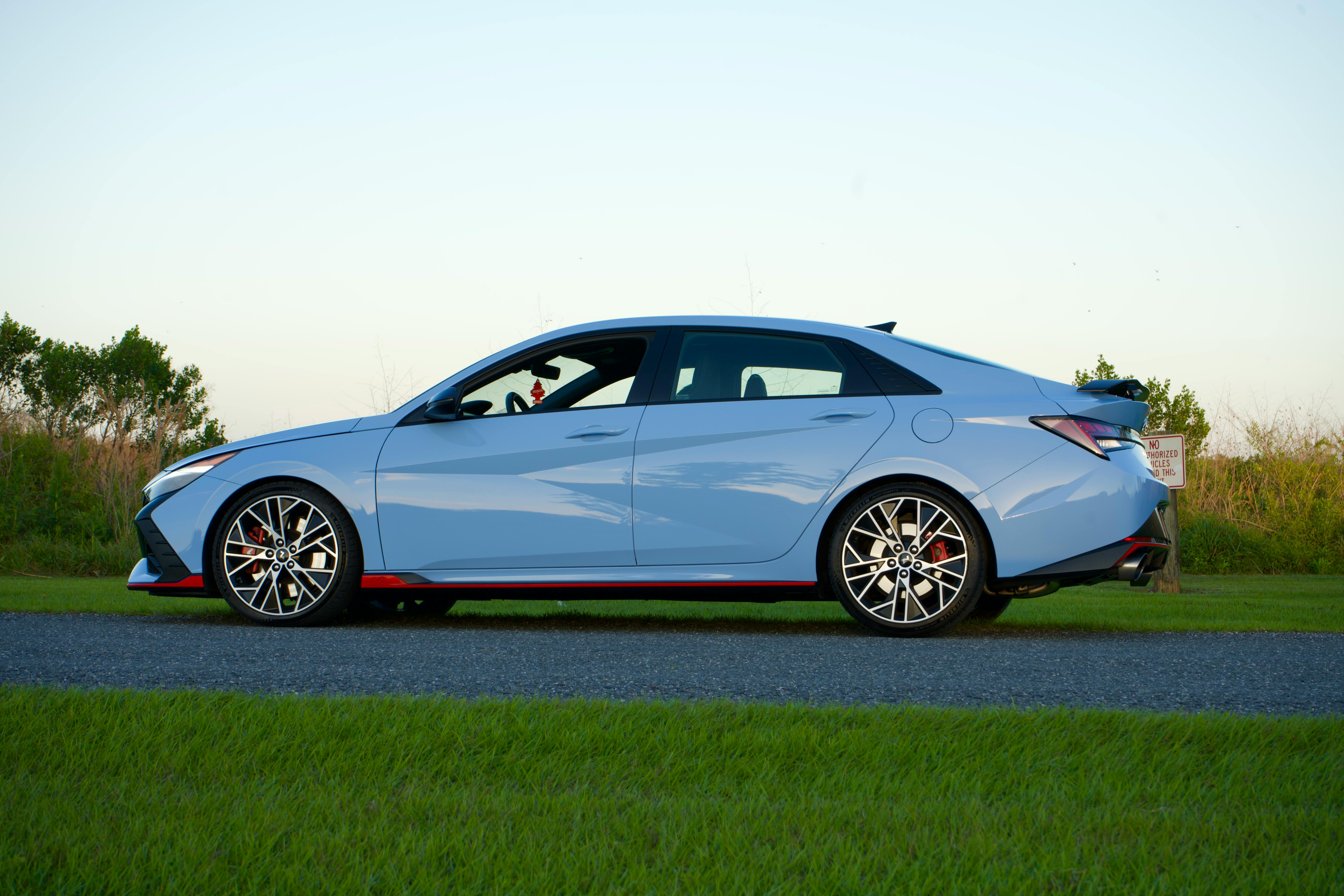 view of a modern hyundai elantra n parked on the side of a road