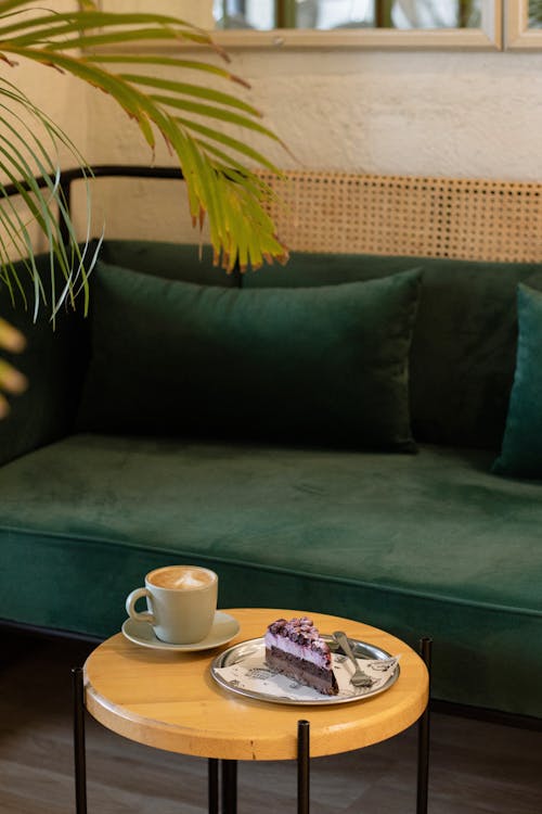 A Slice of Cake and a Coffee on a Table in a Cafe