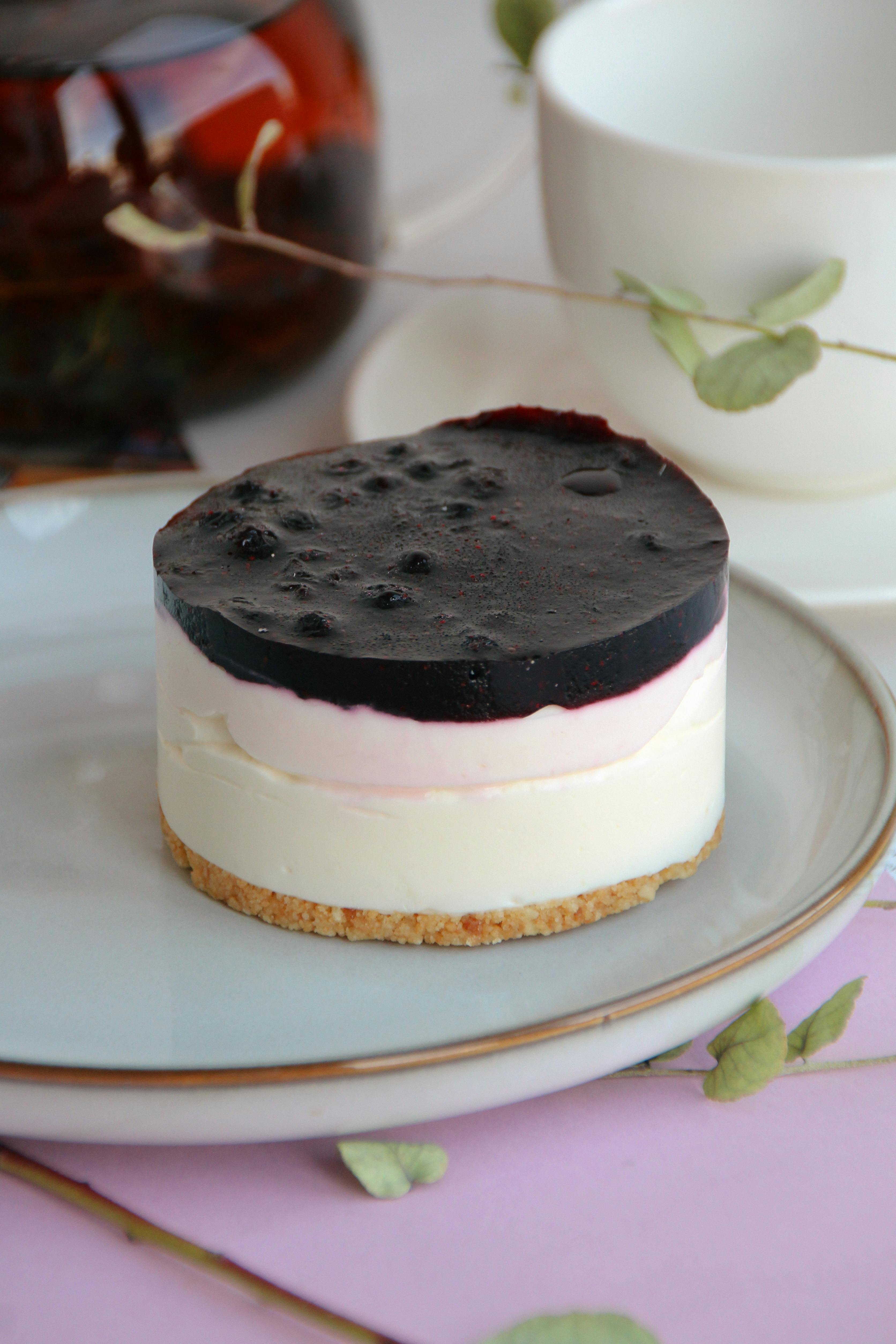 A delectable berry cheesecake with layers on a stylish plate, perfect for dessert themes.