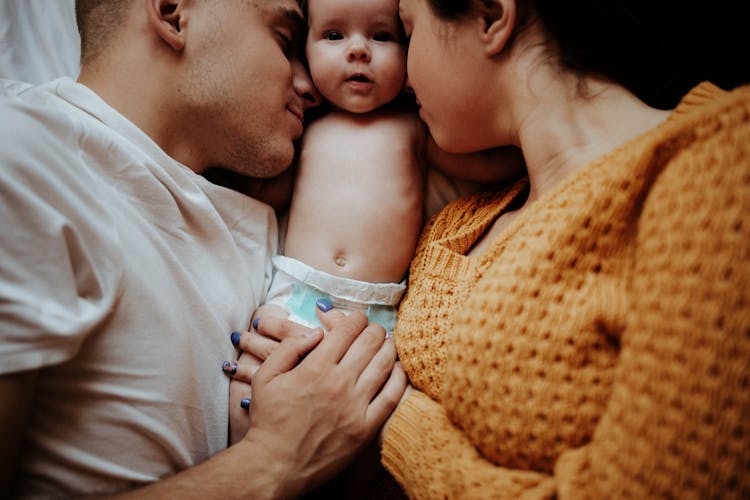 Baby Lying Between Parents