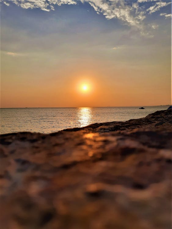 View of Sunset over the Sea from a Beach 