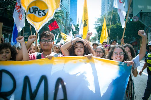 A Group of Young People on a Parade on a City Street 