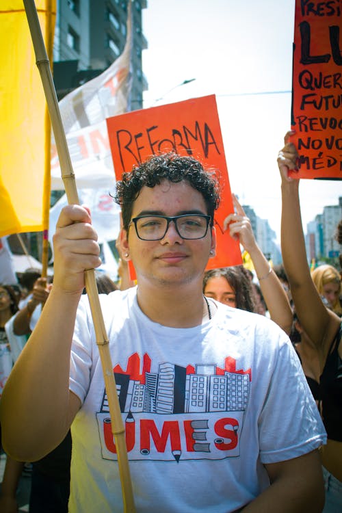 A Young Man on a Parade on a City Street 