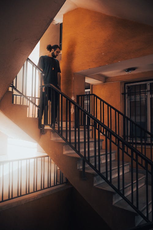 A Man Standing in the Middle of a Staircase