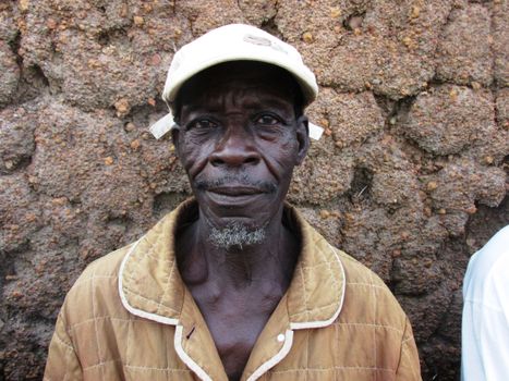 Close-up portrait of an elderly man wearing a cap in Fada-Ngourma, Burkina Faso.