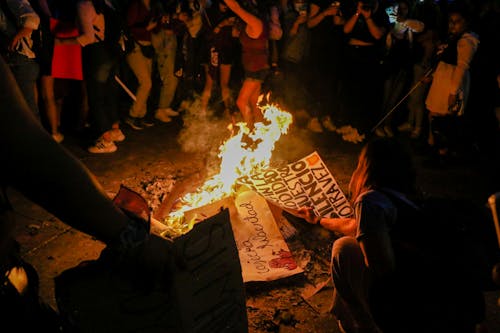 Women Burning Protest Signs in a Bonfire 