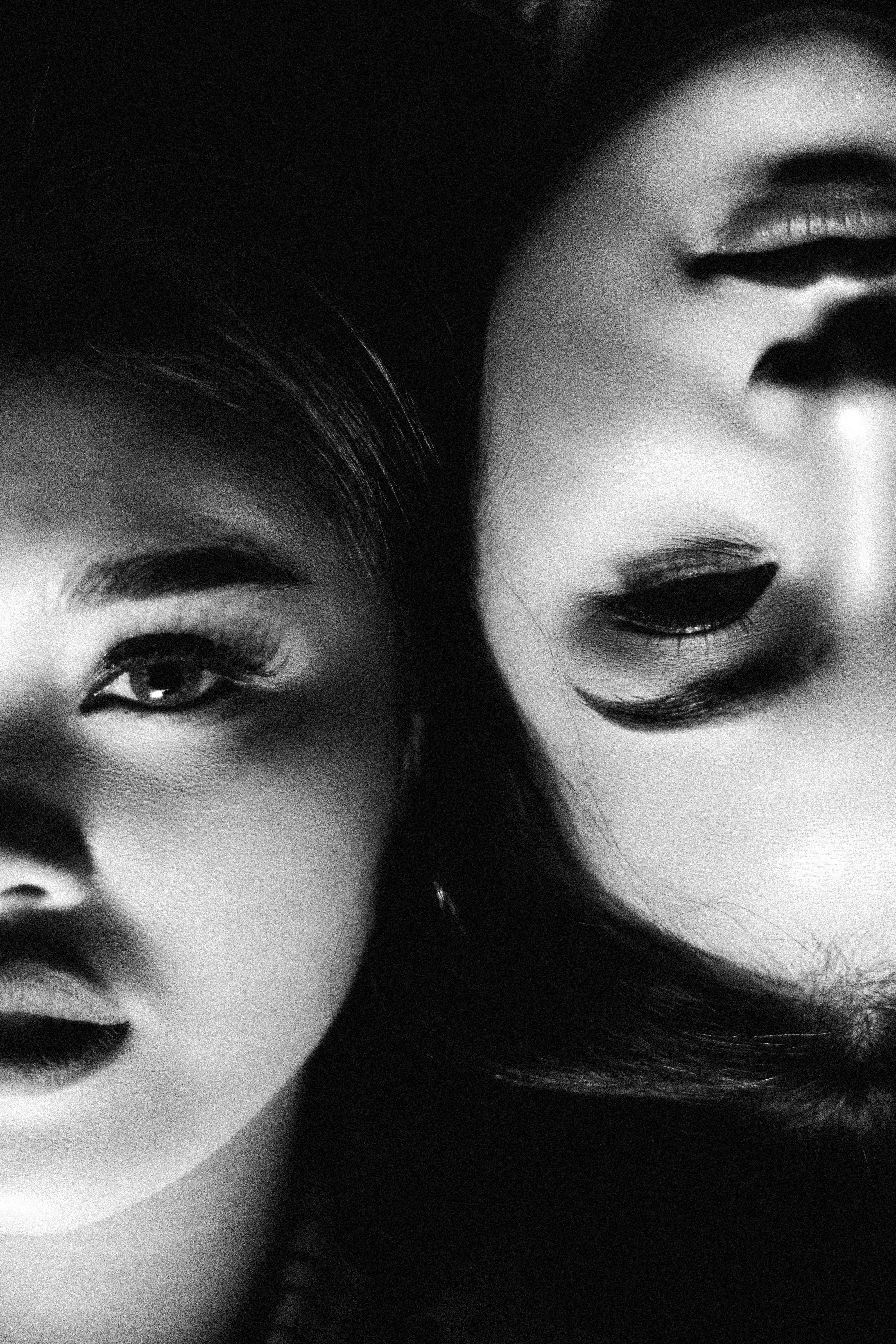 close up of two young women lying next to each other in opposite directions