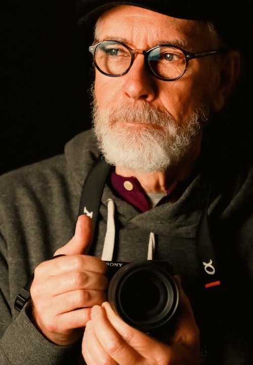 Man with a Gray Beard Holding a Camera