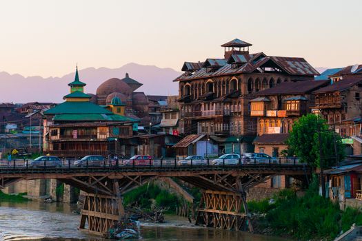 Beautiful view of Zaina Kadal Bridge and urban architecture in Srinagar, India at sunset.