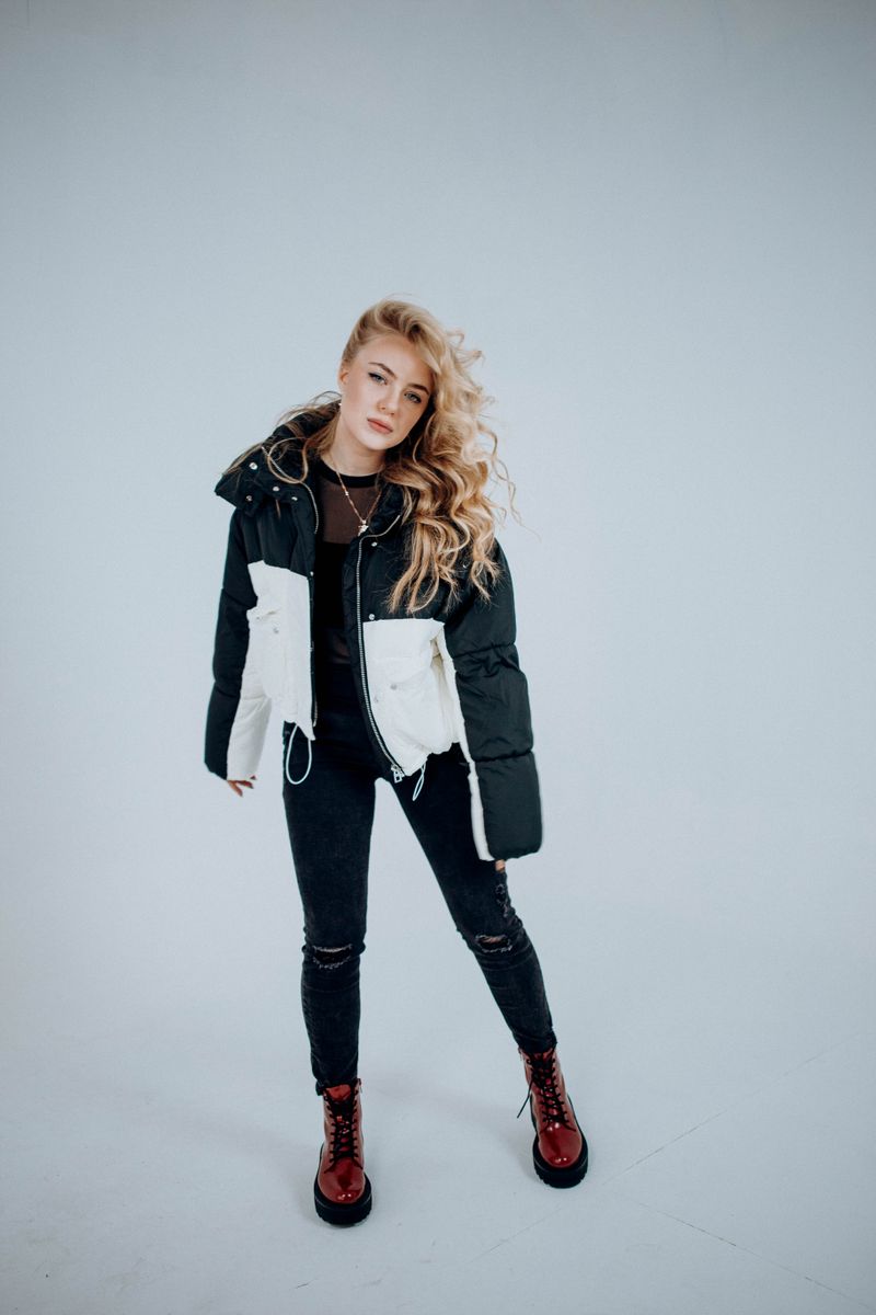 Woman in winter jacket and boots, street style
