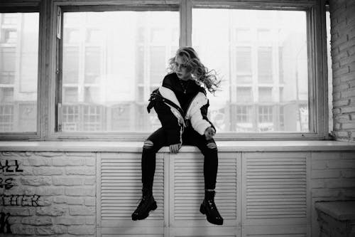Woman Posing on Windowsill in Black and White