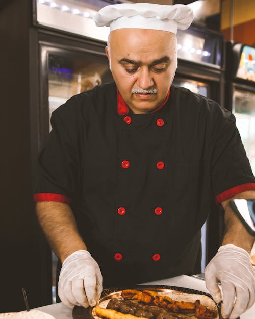 A chef preparing a pizza in a kitchen