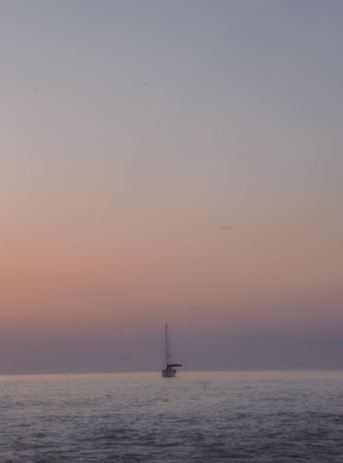 A Sailboat on the Sea at Sunset 