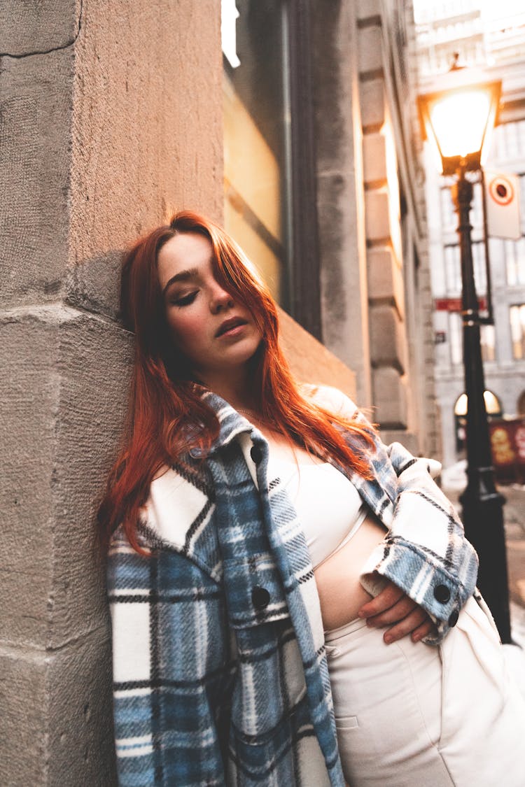 Redhead Woman Leaning On Wall