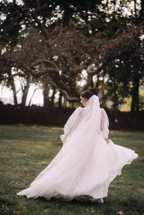 Back View of a Bride Walking in the Garden 