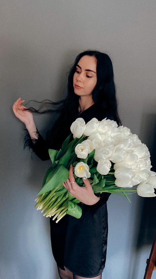 Young Woman Holding a Bunch of White Tulips 