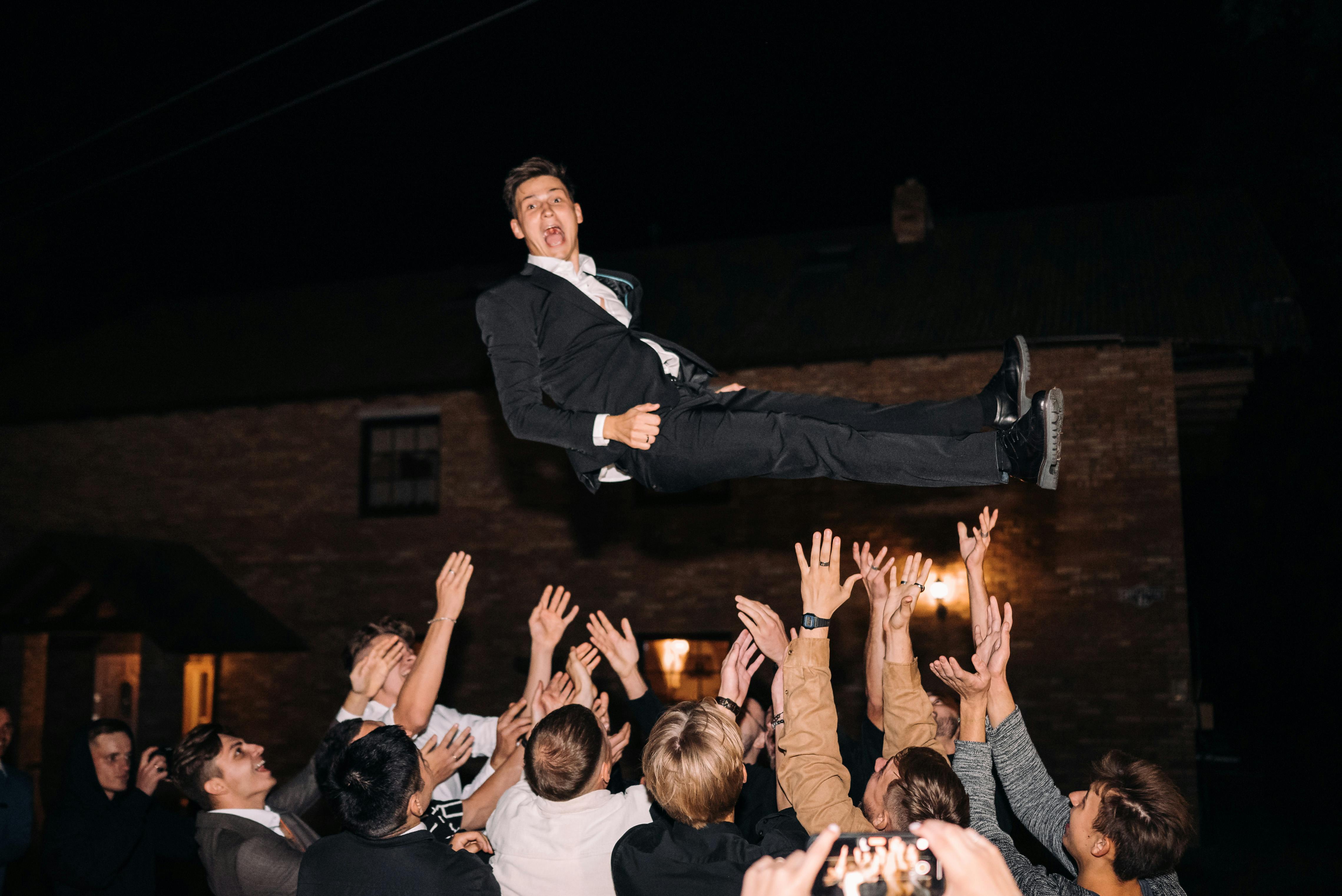Wedding Guests Throwing the Groom in the Air · Free Stock Photo