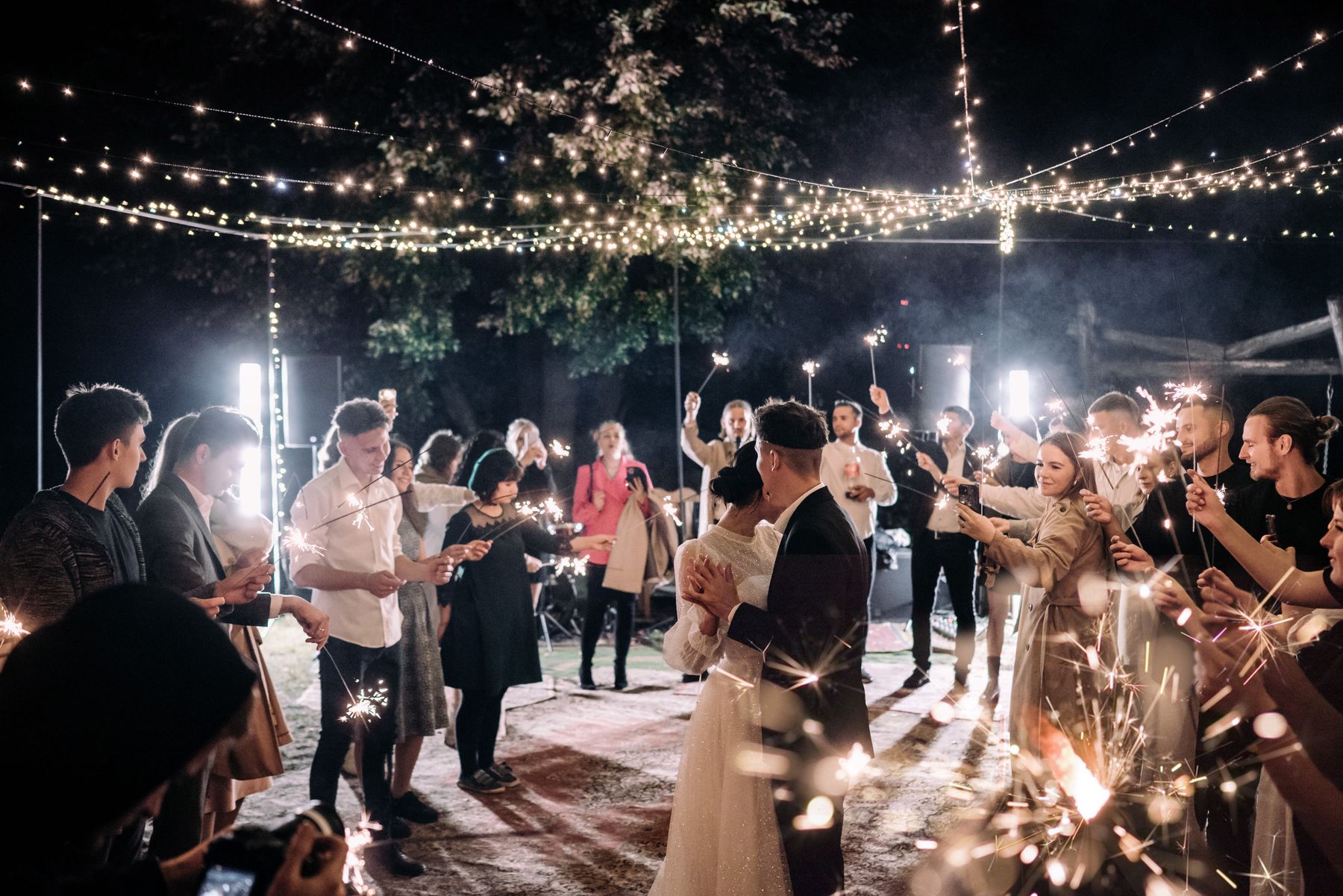 Wedding couple dancing beneath sparklers
