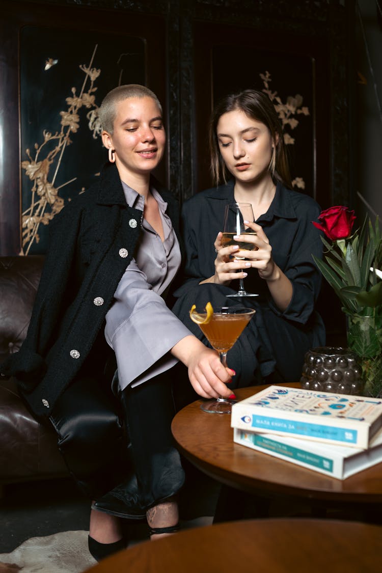 Young Women Drinking Cocktails In A Bar