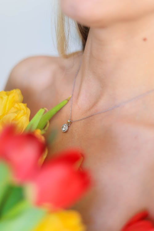 Close-up of Woman Holding a Bunch of Tulips Close to Her Chest 