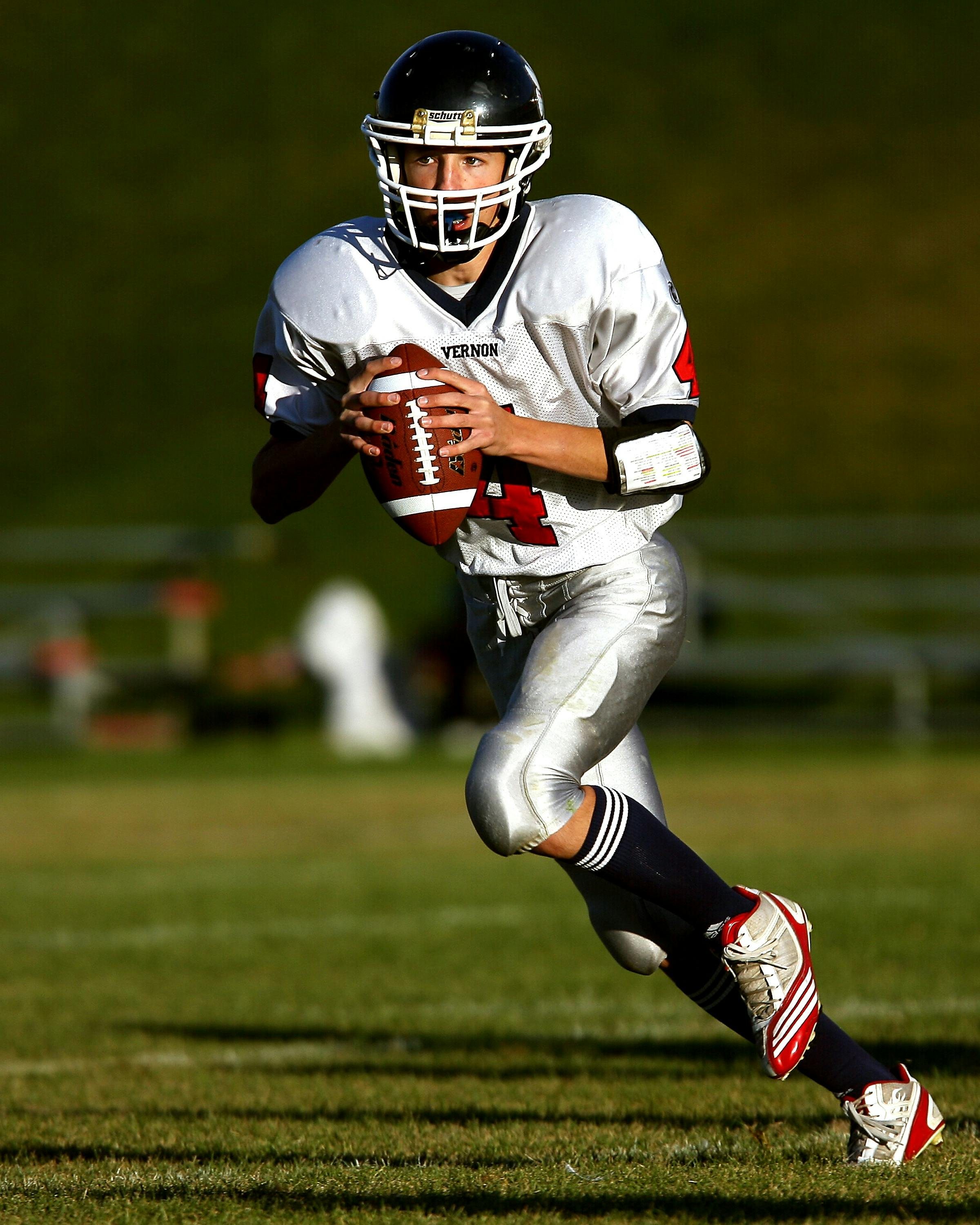 boy playing american football