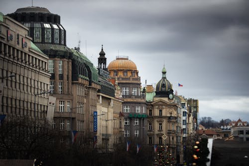 A row of buildings with a cloudy sky above them