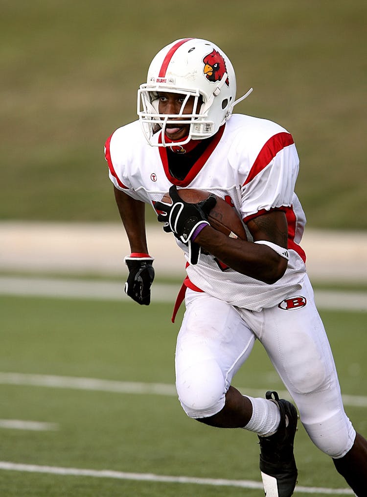 Football Player Running On Football Field