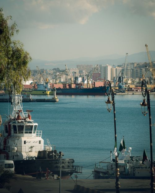 Free Alger Centre's bustling harbor with ships moored, set against a vibrant urban backdrop. Stock Photo