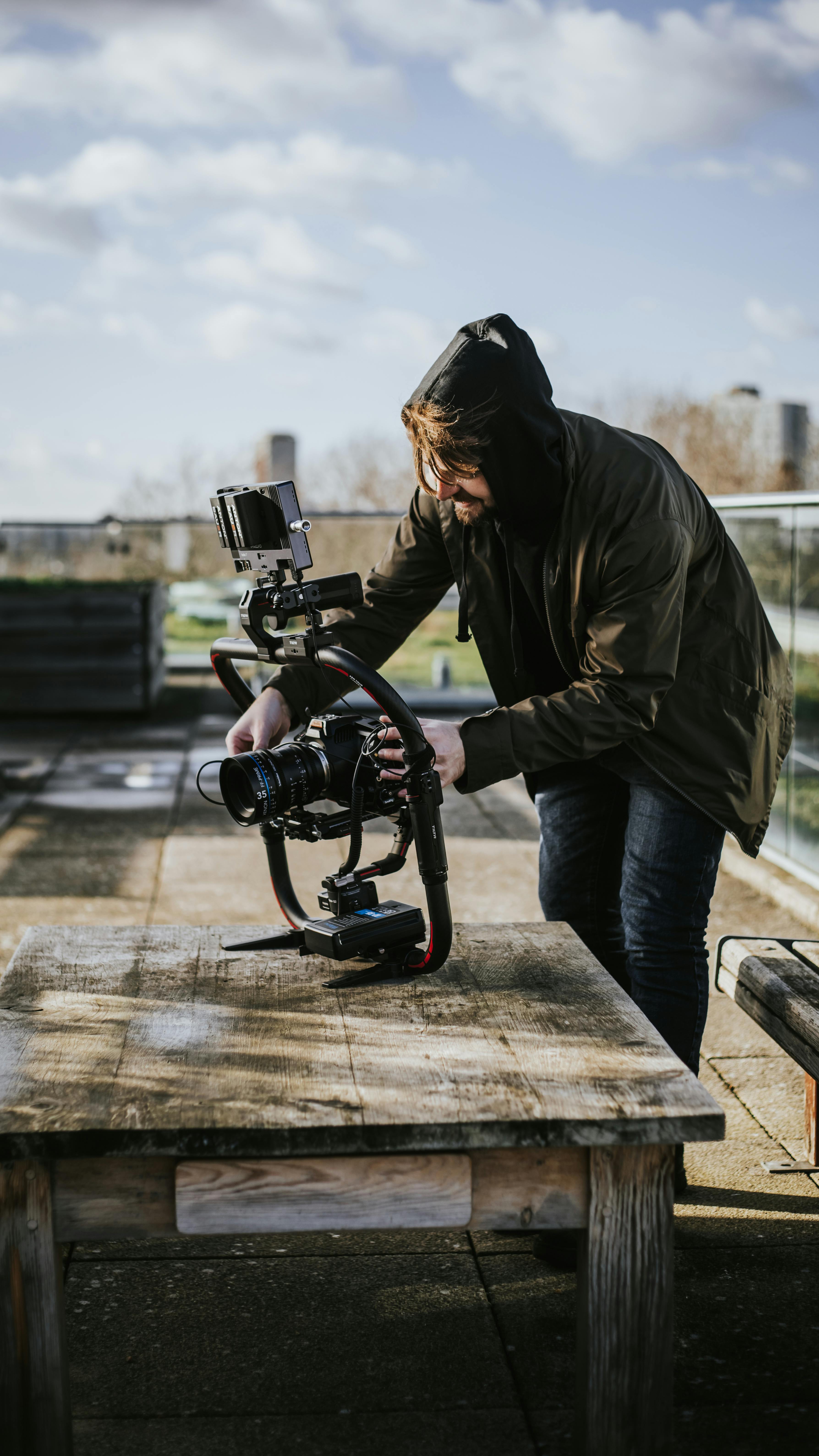 man using a camera with a stabilizer