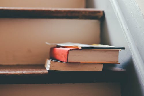 2 Book on Brown Wooden Stair