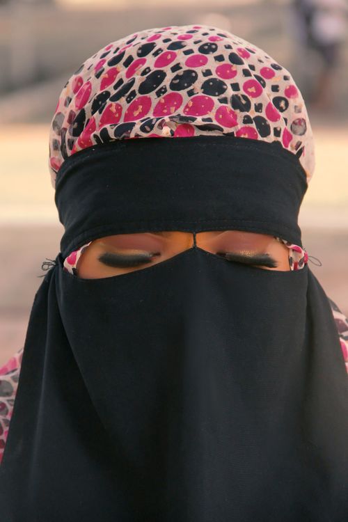 Free Close-up portrait of a woman with closed eyes wearing a colorful hijab and niqab. Stock Photo