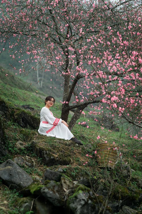 Woman Relaxing by Blossoming Tree