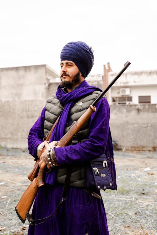 Man in Traditional Clothes with Gun