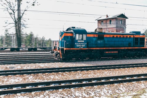 Blue Locomotive on Railway Tracks
