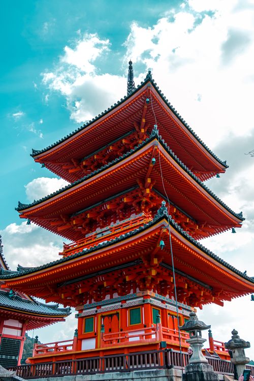 Free Traditional Japanese pagoda architecture against blue sky in Kyoto, highlighting cultural heritage. Stock Photo