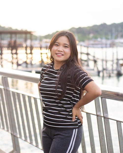 Smiling Brunette in Striped Blouse