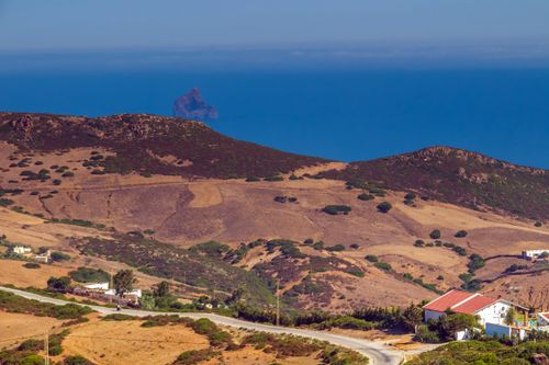 Free Beautiful rural landscape with fields and mountains overlooking the sea in Bizerte, Tunisia. Stock Photo