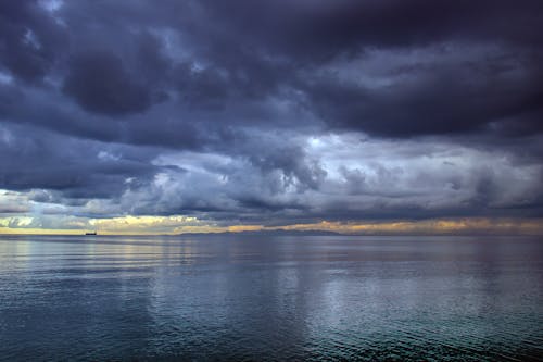 View of a Sea under a Dramatic Sky with Dark Clouds 