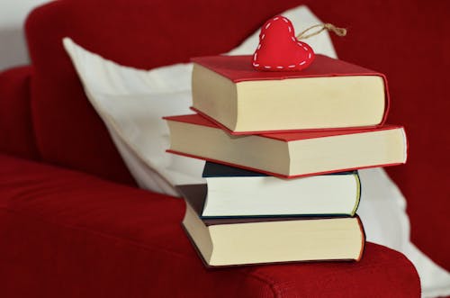 Red Heart Keychain on Top of Stacking of Books