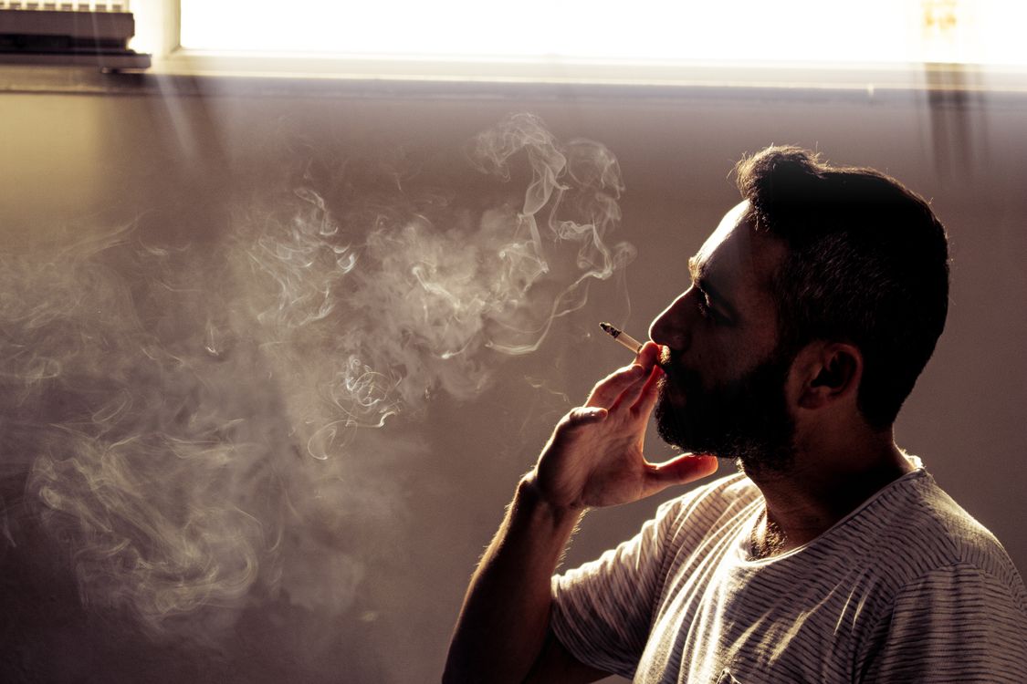 Mane Mosking Man Smoking Cigarette · Free Stock Photo