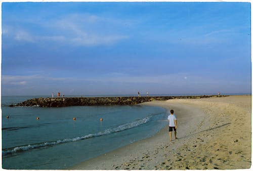 Sandy Beach with Rocky Pier