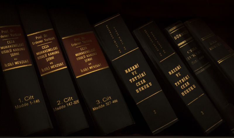 Stack of legal and literature books in a library showcasing various volumes