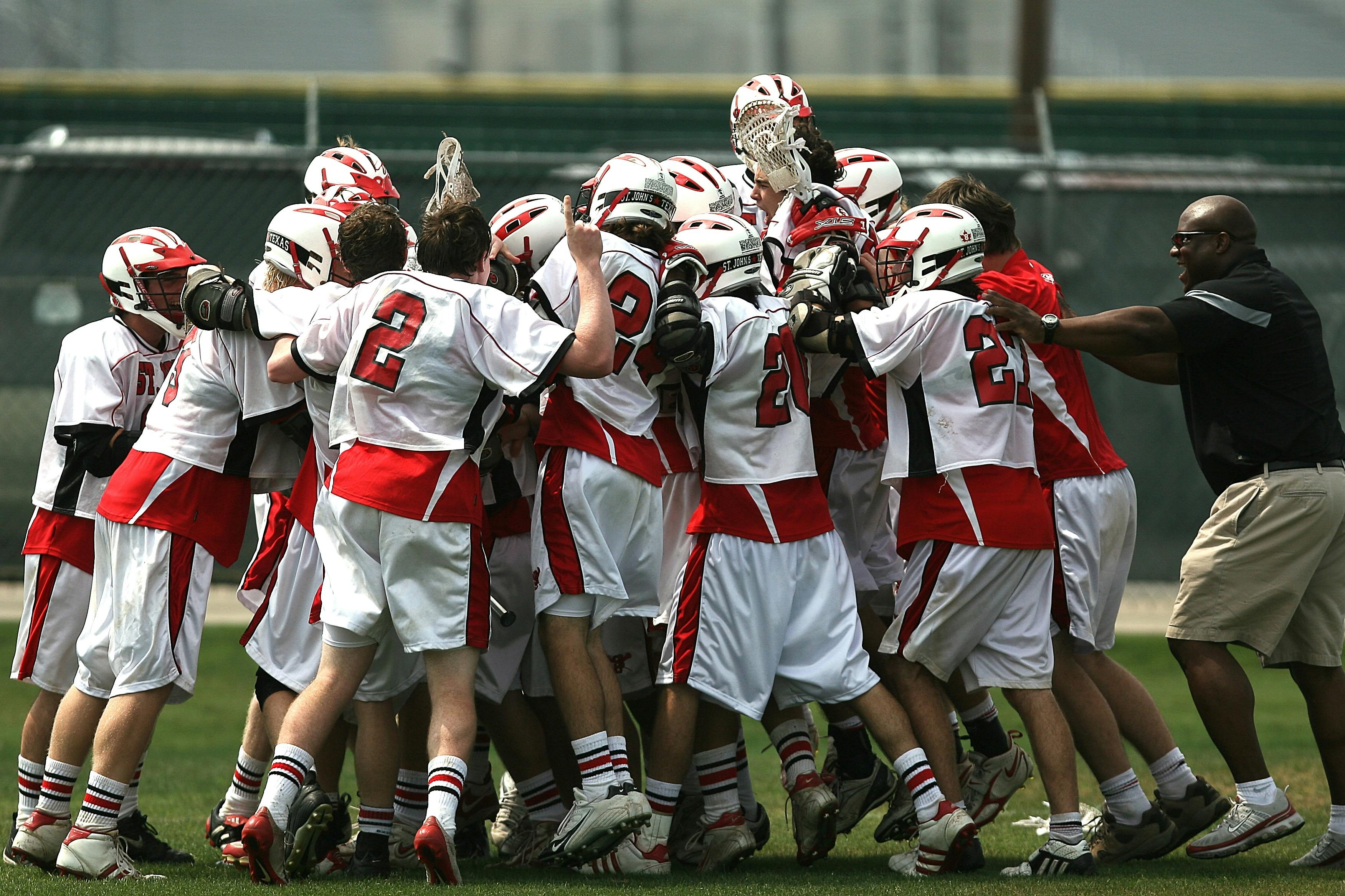 Group of Lacrosse Players Celebrating With Coach during Daytime \u00b7 Free Stock Photo