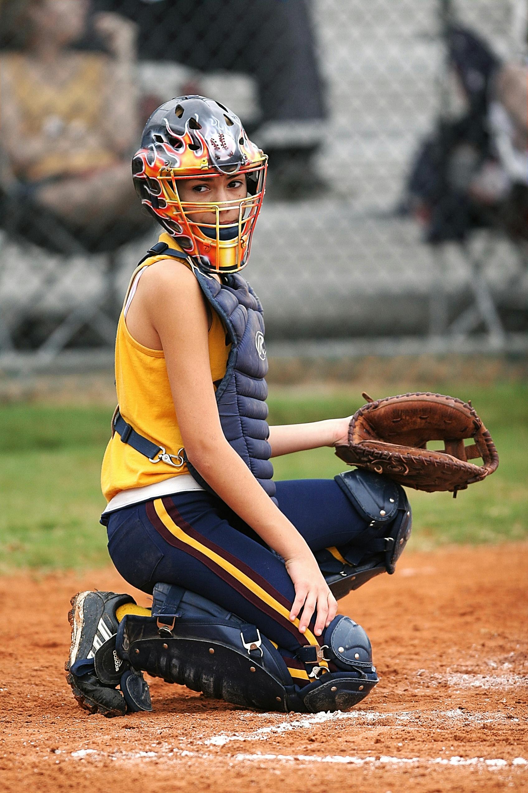 female baseball catcher portrait photo during the game at daytime